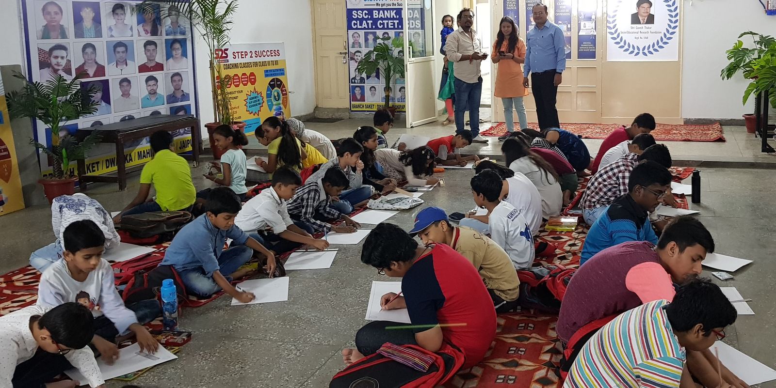 Dozens of children drawing at a competition